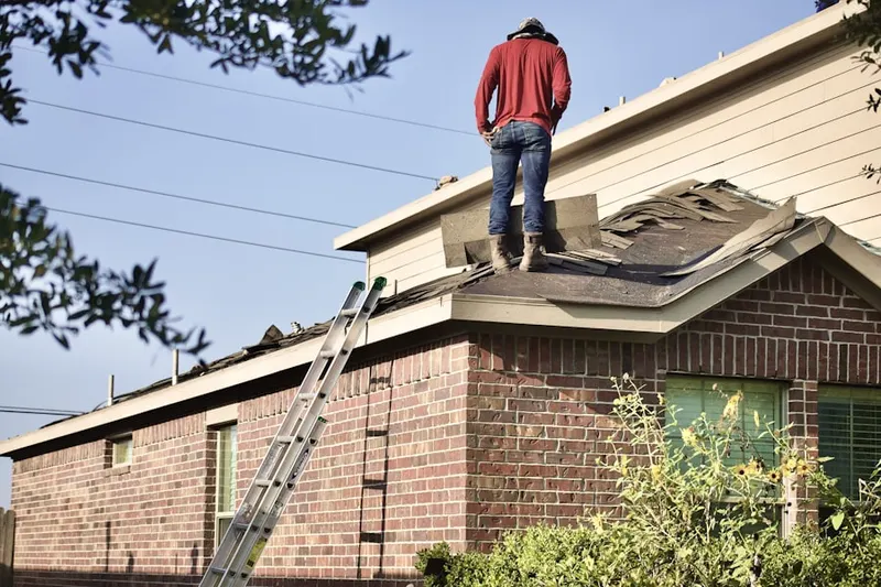 Professional roofer working on a residential roof in Myersville
